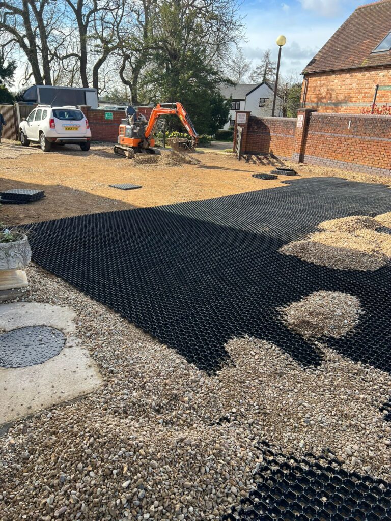 Mini digger and finished gravel driveway dugout at a residential property