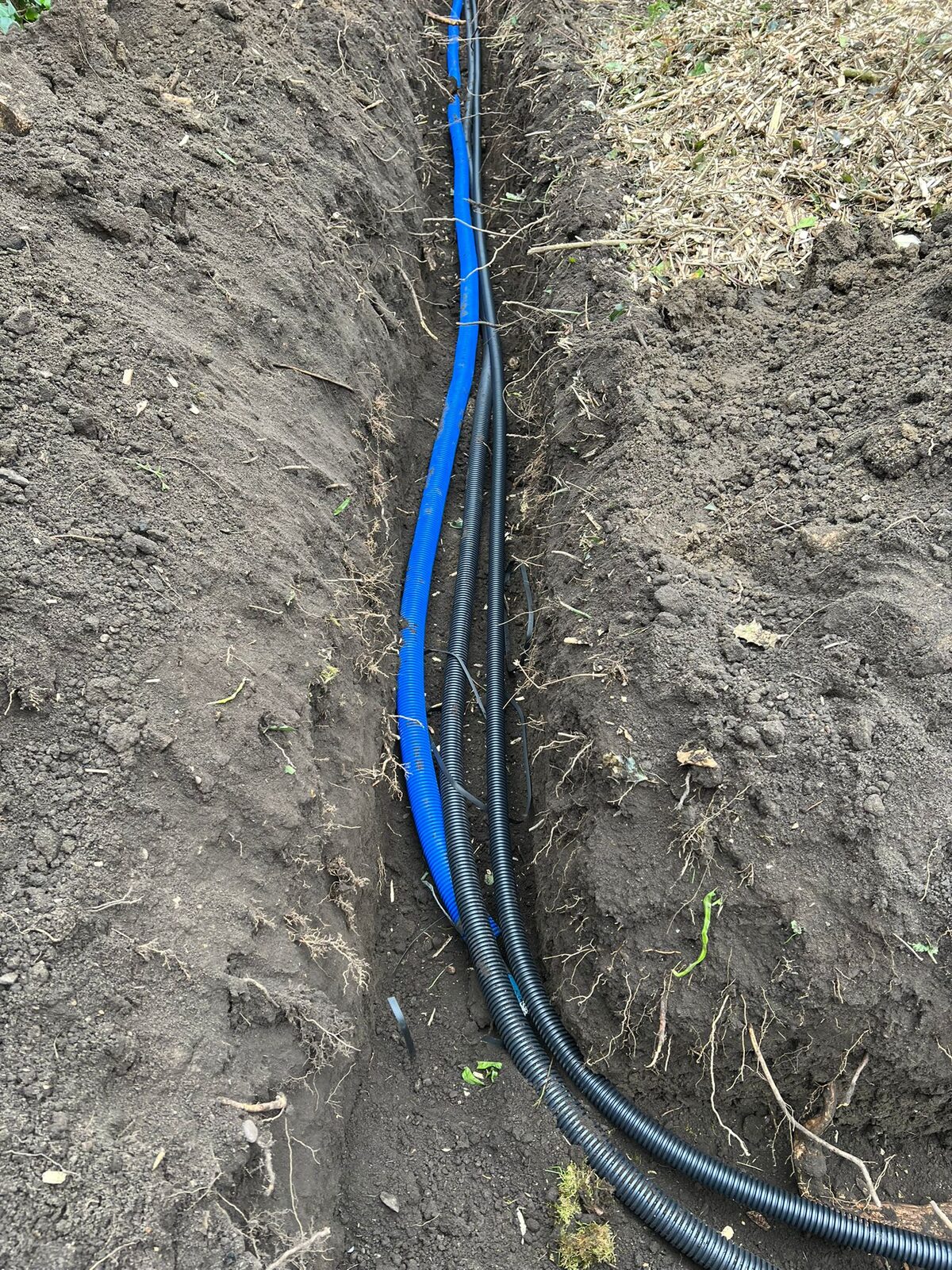Pipe and duct close-up in trench