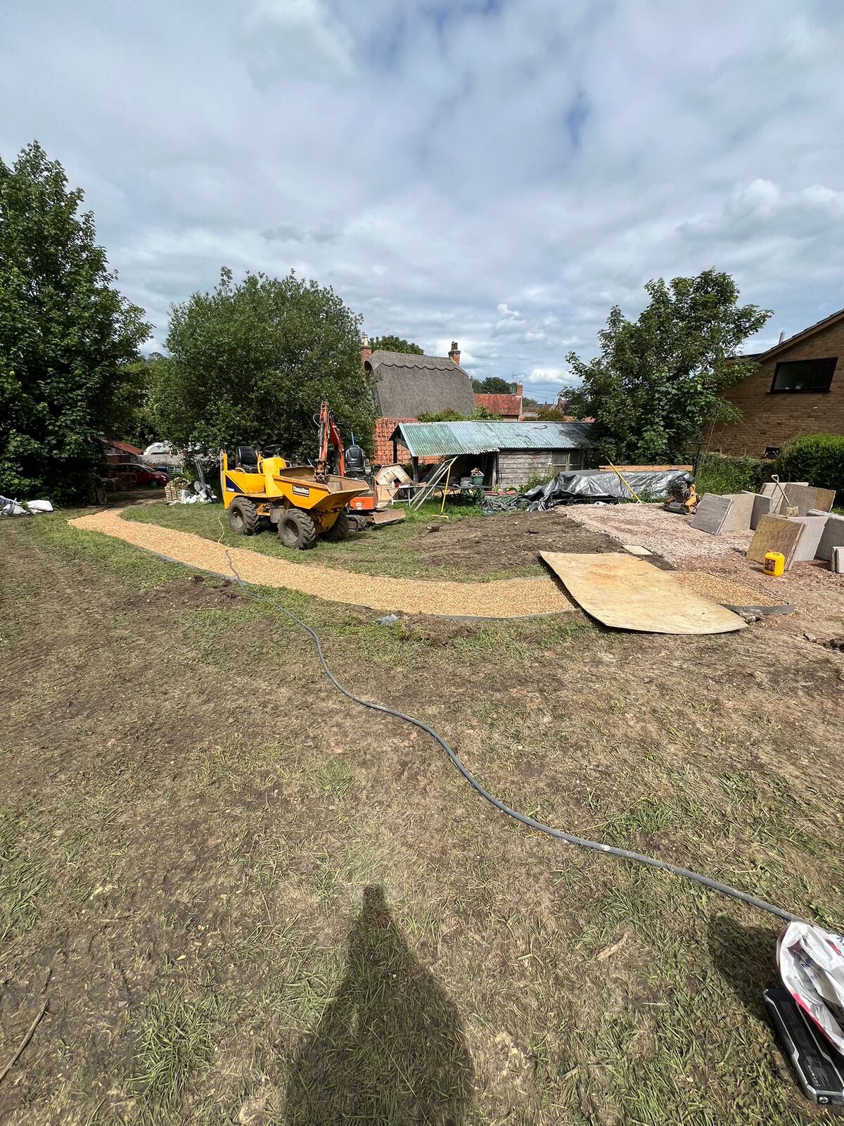 Dumper truck working across a garden